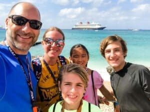Disney Cruise (2019) Family selfie at the beach with a Disney Cruise ship in the background, highlighting memorable vacation experiences.