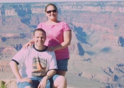 Couple posing at the Grand Canyon, showcasing stunning layered rock formations and expansive landscape, reflecting personal travel experiences relevant to vacation planning.