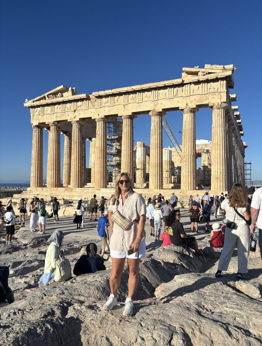 Lora Bohannon standing in front of the Parthenon at the Acropolis in Athens, Greece